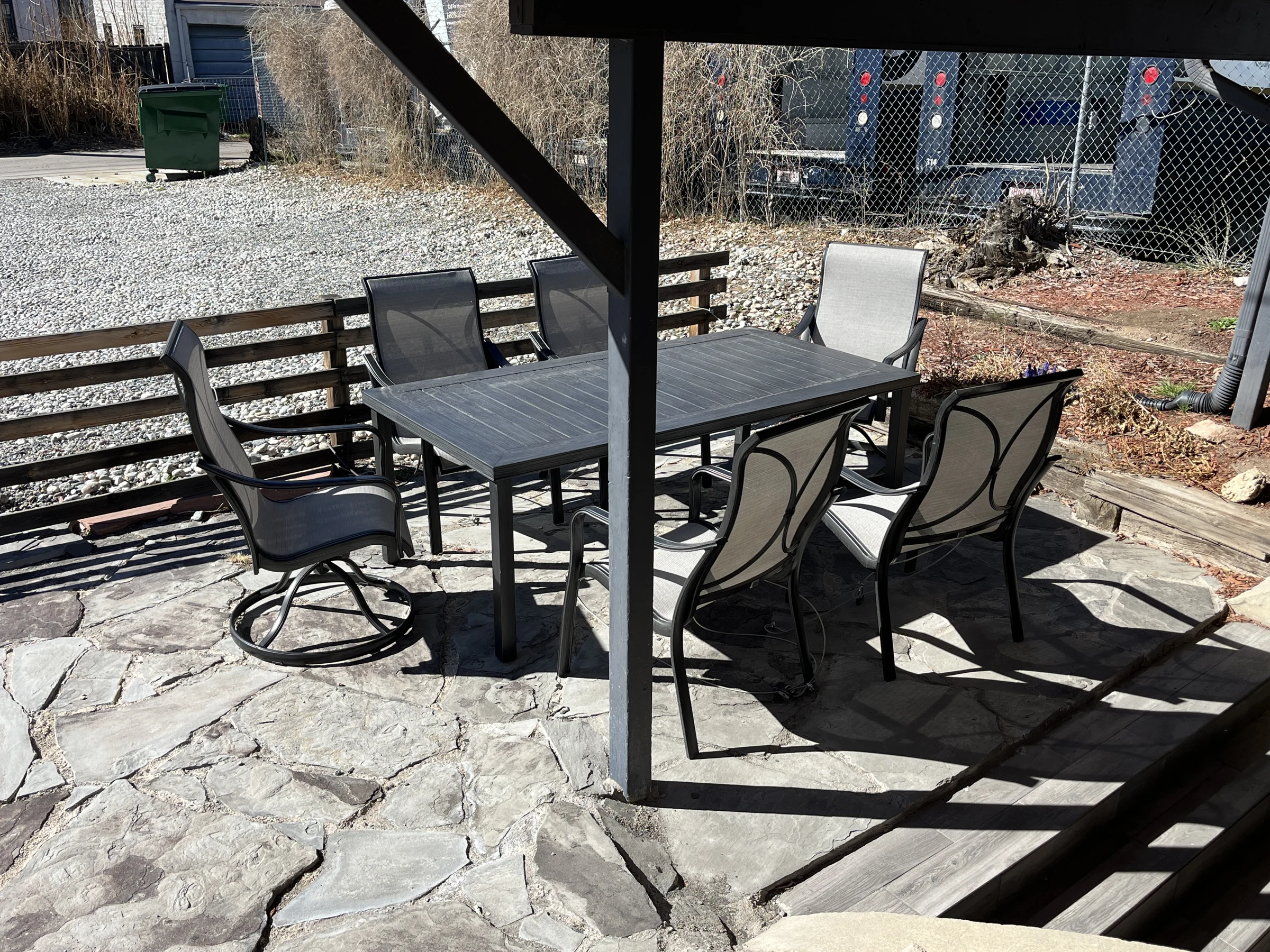 Outdoor table and chairs on a flagstone courtyard
