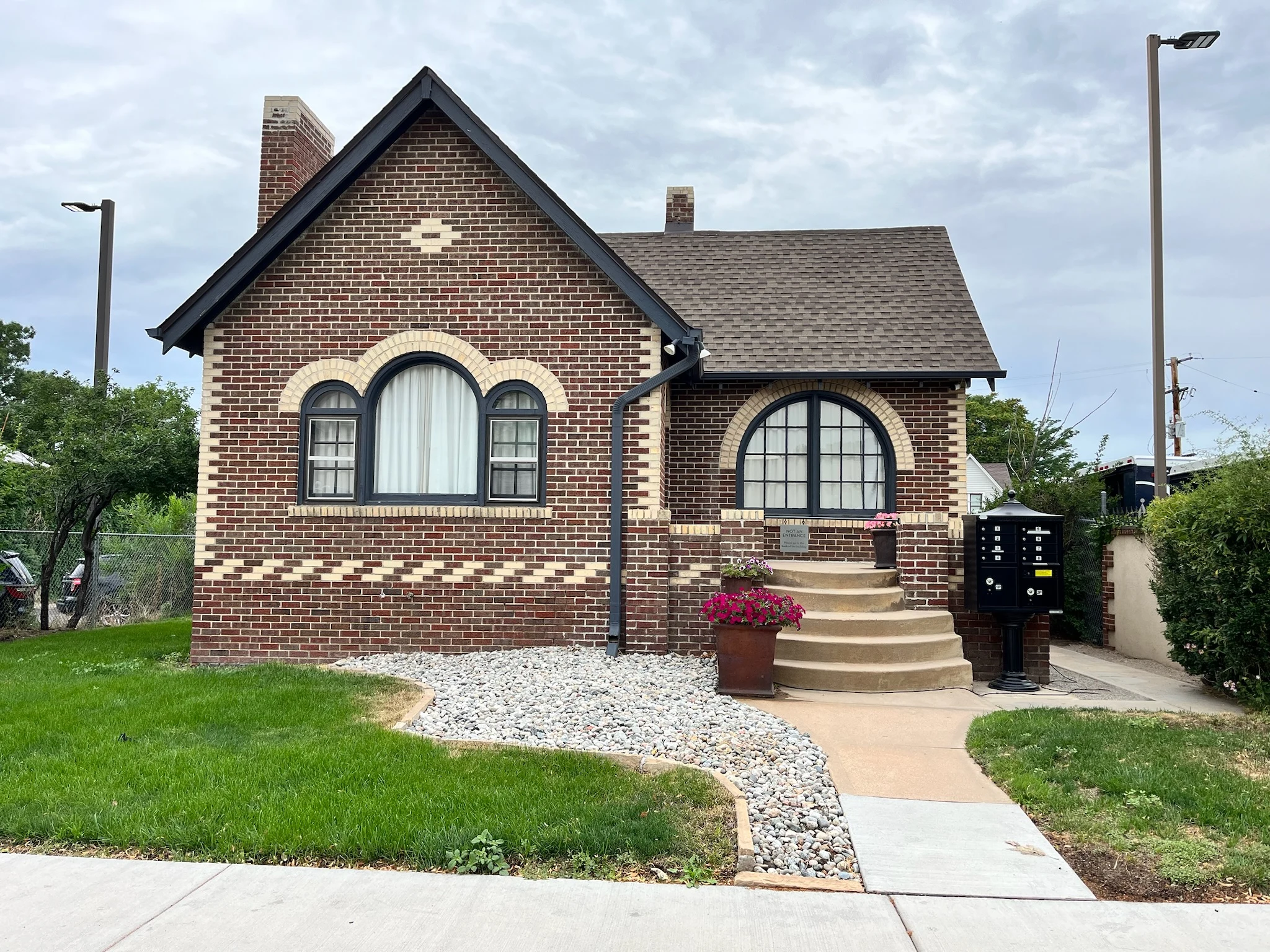Historic brick Dairy Hills building with arched windows and a front stairway